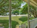 View from the porch of the home, overlooking the spacious front yard and tranquil, tree-lined street at 105 Birch Creek Cir, Mcdonough, GA 30253