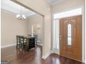 Inviting foyer with dark wood floors, an adjacent dining area, and front door with side-light window at 570 Mcgarity Dr, Mcdonough, GA 30252