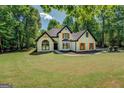 Charming white brick home with black trim and wood shutters at 857 Cooper Rd, Social Circle, GA 30025
