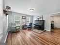 Relaxing living room with two windows, hardwood floors and a piano at 715 Frog Rd, Locust Grove, GA 30248