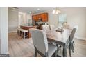 Open-concept dining area featuring a modern table set and hardwood floors at 5237 Halcyon Ct, Morrow, GA 30260