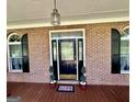 Charming entryway with a decorative glass front door, brick walls, and elegant light fixture at 382 Knox Chapel Rd, Social Circle, GA 30025