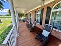 Inviting front porch featuring classic rocking chairs, brick walls, and stylish windows with black shutters at 382 Knox Chapel Rd, Social Circle, GA 30025