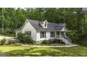 Well-maintained home featuring white siding and a lush, green lawn at 3180 Sweetbriar Dr, Villa Rica, GA 30180