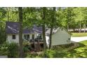 Features a spacious back deck, with steps down to the yard, surrounded by trees at 3180 Sweetbriar Dr, Villa Rica, GA 30180