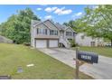Charming two-story home featuring a two-car garage and a mailbox with number at 1341 Huey Rd, Douglasville, GA 30134