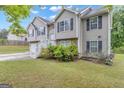 Charming two-story home with landscaped yard, showcasing its appealing architectural design at 1341 Huey Rd, Douglasville, GA 30134