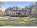 Charming single-story home with inviting front porch, white siding, and a lush green lawn at 1234 Coweta Heard Rd, Hogansville, GA 30230