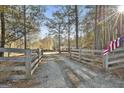 Scenic property view featuring a long gravel driveway leading to a beautiful house surrounded by trees at 1234 Coweta Heard Rd, Hogansville, GA 30230