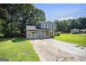 Beautiful two-story home with a well-maintained lawn and mature trees at 6369 Havenridge Dr, Riverdale, GA 30274