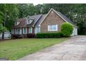 Charming brick home with well-maintained landscaping and a spacious driveway at 8039 Woods Ln, Jonesboro, GA 30236