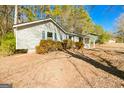 Attractive single-story home featuring a covered porch and blue trim and a well-maintained lawn at 8479 Alden Dr, Riverdale, GA 30274