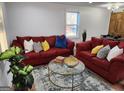 Inviting living room featuring hardwood floors, red sofas with throw pillows, and stylish decor at 95 Mccoy Dr, Carrollton, GA 30116