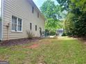 View of the backyard with a table, chairs, and green grass at 130 Floss Flower Ct, Roswell, GA 30076