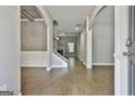 Light-filled foyer featuring hardwood floors, elegant archways, and staircase with iron spindles at 70 Pacific Ave, Sharpsburg, GA 30277