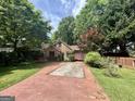 Charming brick home featuring a well-manicured lawn and mature trees in a desirable neighborhood at 725 Brown Pl, Decatur, GA 30030