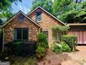 Close up of a brick house exterior featuring plants and a brick walkway, enhancing its curb appeal at 725 Brown Pl, Decatur, GA 30030