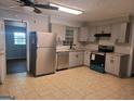 Modern kitchen with stainless steel appliances, granite countertops, and ample cabinet space, great for cooking and entertaining at 7588 Covington Hwy, Lithonia, GA 30058