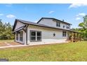This country farmhouse features a covered wooden porch and a spacious yard at 2955 Peeksville Rd, Locust Grove, GA 30248