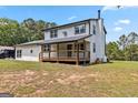 This house features a back porch, a yard and a star hanging on the side at 2955 Peeksville Rd, Locust Grove, GA 30248