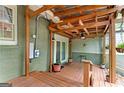 Covered back porch featuring wood flooring, ceiling fan, outdoor lighting, and access to backyard at 2364 Woodside Way, Atlanta, GA 30341