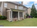 Cozy screened-in porch adjacent to a stone patio with outdoor seating and barbecue area at 4769 Moon Hollow Ct, Buford, GA 30519