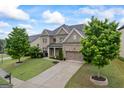 Beautiful brick home with a well-kept lawn, two-car garage, and a serene landscaped garden at 4769 Moon Hollow Ct, Buford, GA 30519