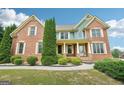 Charming two-story brick home featuring manicured landscaping and a welcoming front porch at 1979 Alcovy Shoals Blf, Lawrenceville, GA 30045
