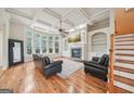 Inviting living room with a fireplace, built-in shelves, coffered ceilings and gleaming wood floors at 1979 Alcovy Shoals Blf, Lawrenceville, GA 30045