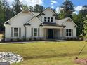 Charming single-Gathering home featuring a symmetrical facade, stone accents and well-manicured front lawn at 555 Discovery Lake Dr, Fayetteville, GA 30215