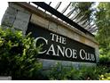 Stone monument sign for The Canoe Club featuring decorative shrubbery and a pergola at 555 Discovery Lake Dr, Fayetteville, GA 30215