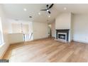 Spacious living room with vaulted ceiling, fireplace, light hardwood floors and a ceiling fan at 5582 Rockingwood Ct, Atlanta, GA 30349