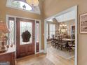 Inviting foyer with beautiful front door and hardwood floors lead into the dining area at 1466 Lake Forest Ln, Mcdonough, GA 30253