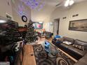 Cozy living room featuring a Christmas tree, vaulted ceilings, and open access to the dining area at 177 Villa Rosa Way, Temple, GA 30179