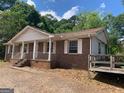 Beautiful brick house with a covered front porch, showcasing curb appeal and a welcoming entrance at 13090 Brown Bridge Rd, Covington, GA 30016