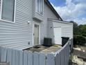 Back exterior of the home featuring gray siding, patio, and white doors at 237 Country Club Dr, Jonesboro, GA 30238