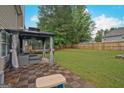 Relaxing backyard patio area with outdoor seating, perfect for entertaining or enjoying the outdoors at 6697 Princeton Park Walk, Lithonia, GA 30058