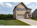 Two-story home featuring a spacious two-car garage and a beautifully maintained lawn at 8045 Coleson Xing, Locust Grove, GA 30248