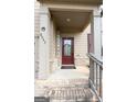 Inviting front porch with a charming welcome sign, brick steps, and a decorative wreath on the front door at 8045 Coleson Xing, Locust Grove, GA 30248