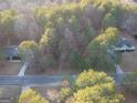 An aerial view of a home surrounded by green trees in a neighborhood at 323 Nicole Dr, Temple, GA 30179