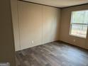 Cozy bedroom showcasing hardwood floors and a view of the outdoors through a window at 30 Alyssa Ln, Bowdon, GA 30108