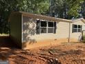 Side view of a tan single-story house with siding and a block foundation at 30 Alyssa Ln, Bowdon, GA 30108