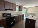 Kitchen features modern appliances, granite countertops, and a breakfast bar with wood-look flooring at 30 Alyssa Ln, Bowdon, GA 30108