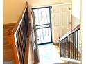 A light filled foyer and staircase with hardwood floors, flowing into the front entrance at 2425 Wood Valley Dr, Morrow, GA 30260