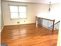 Spacious living room with hardwood flooring, natural light, and a staircase at 2425 Wood Valley Dr, Morrow, GA 30260