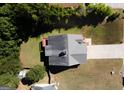 Aerial view of a home with a large backyard, deck, and a well-maintained lawn and mature trees in the background at 10074 Tara Glynn Dr, Hampton, GA 30228