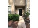 Beige two-story home with a dark-colored front door, symmetrical design, and a well-maintained lawn at 2320 Coach Way, Jonesboro, GA 30236
