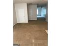 Spacious living room featuring neutral carpet, white doors, and an open floor plan, great for entertaining at 2320 Coach Way, Jonesboro, GA 30236