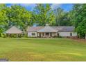 Spacious backyard with a well-maintained lawn and patio perfect for outdoor entertaining at 877 Honey Creek Rd, Mcdonough, GA 30252