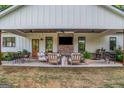 Inviting covered back porch with comfortable seating and an outdoor kitchen area at 877 Honey Creek Rd, Mcdonough, GA 30252